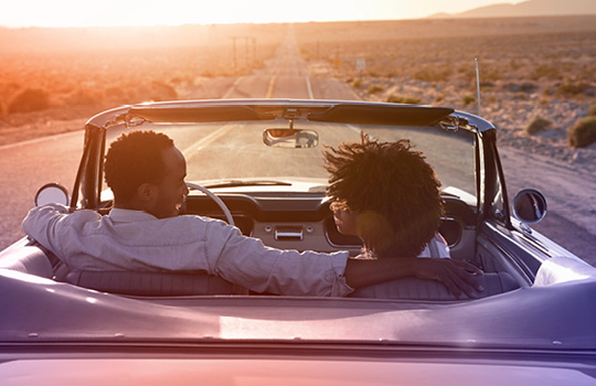 Two people driving on the open road