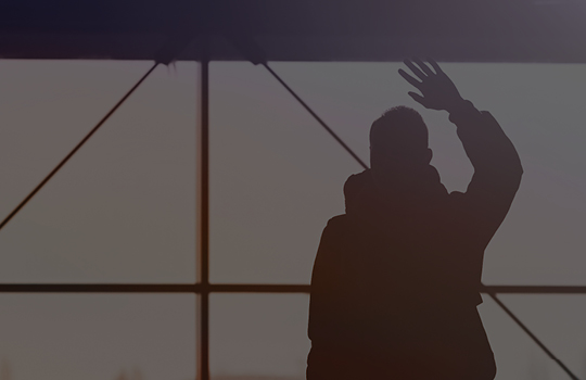 A person waves goodbye.
