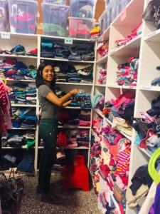 Lionbridge Finland employee sorting clothes with Hope charity organization