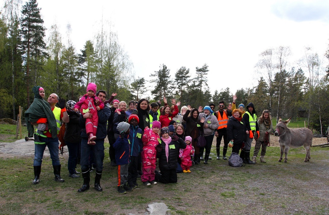 Lionbridge's Finland team poses poses with volunteers at nature conservatory