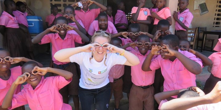 Lionbridge's Vicky Smith making a funny face with children from Ghana for her lionbridge volunteer day