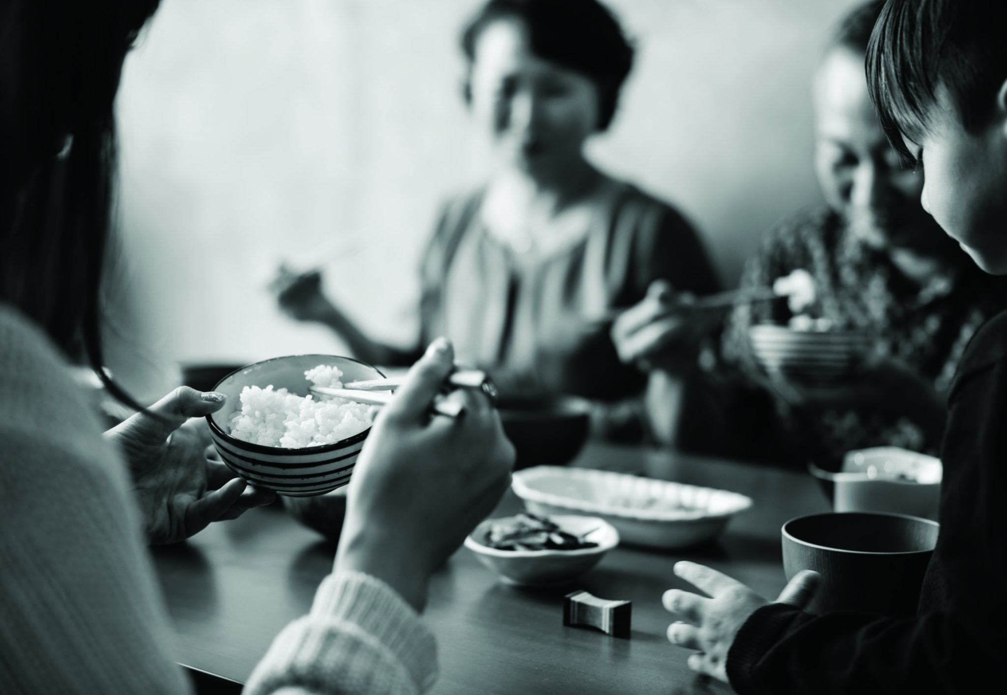 Japanese family eating around dinner table