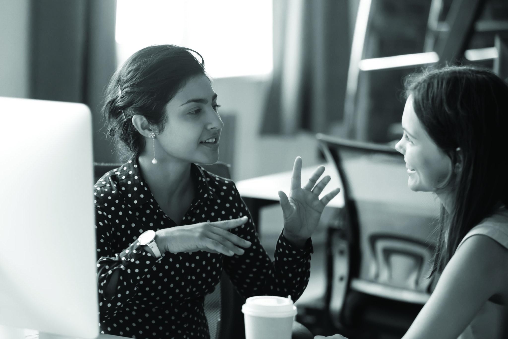 Women talking in office setting