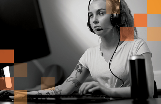 Trendy person with tattoos working on computer 