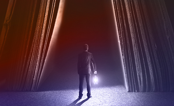 Man holding a lamp trying to light a dark path