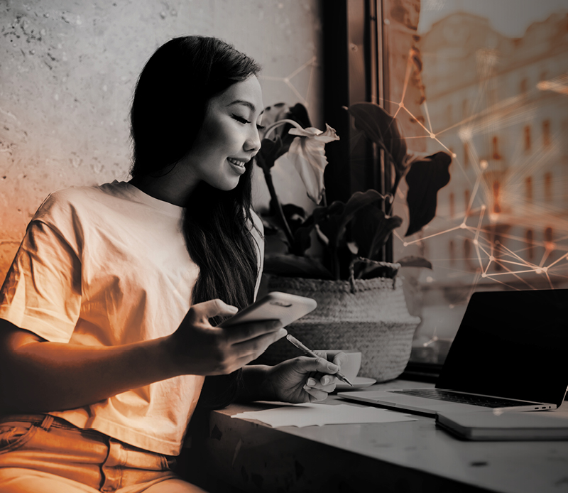 Woman working on laptop and mobile phone