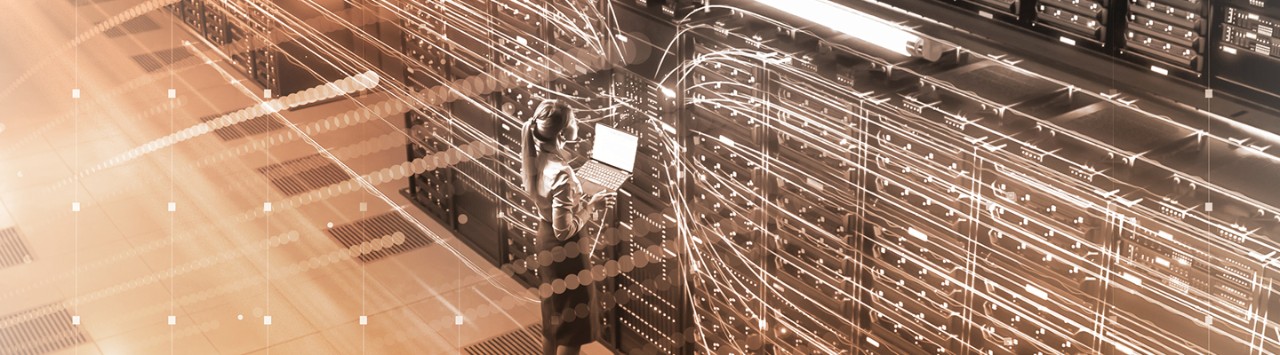 person standing at servers with digitized connecting lines