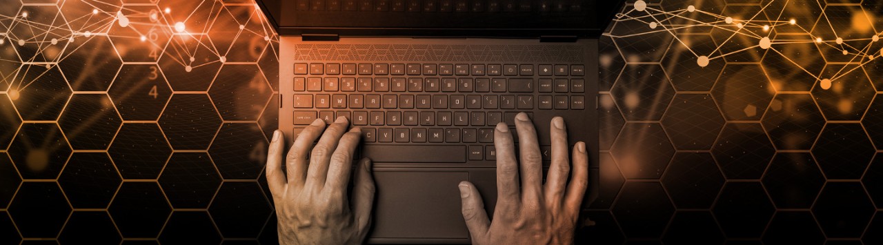 Two hands typing on keyboard