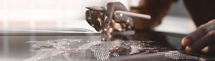 Hand pointing at a digital map illustrating global communication and high-quality translations. 