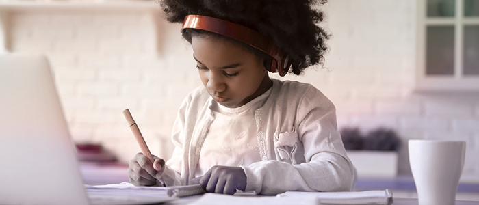 A schoolgirl learning in front of a computer 