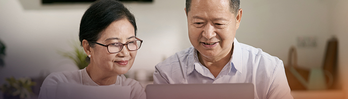 Members looking at a computer together. 