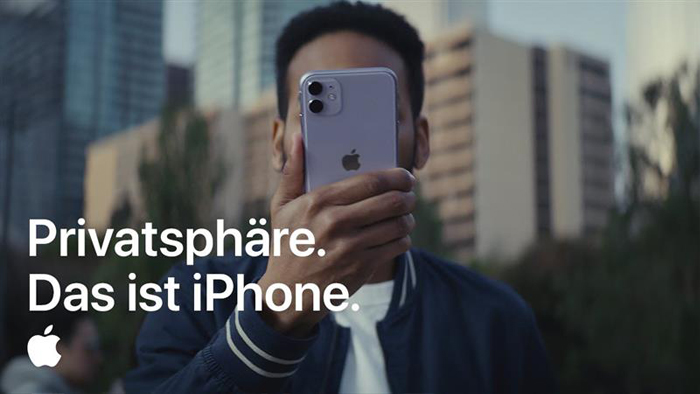 Advert of person holding phone with German text