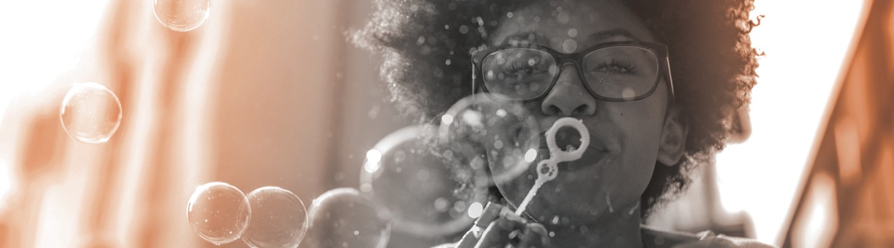 person happily blowing bubbles