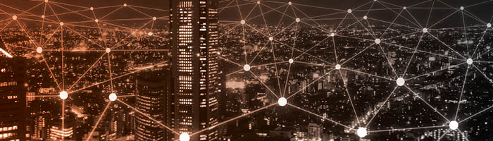 A geographic pattern overlays a cityscape at night