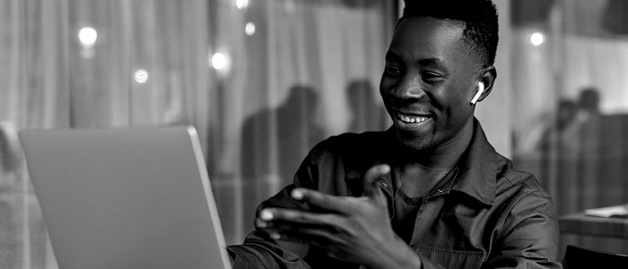 Smiling man looking at laptop screen