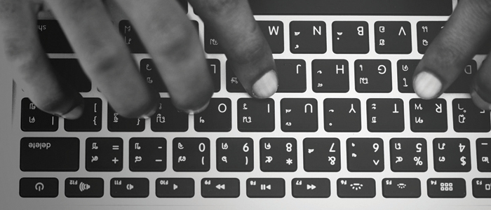A person typing on a keyboard