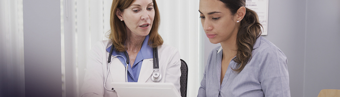 A doctor communicating with a patient with Limited English Proficiency through professional interpretation services. 
