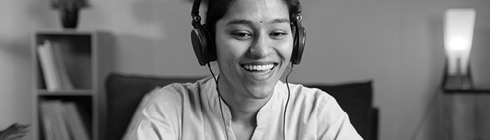 A woman laughing on a headset