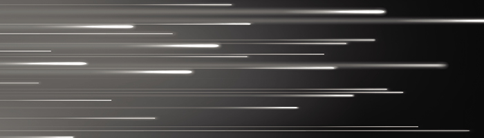 Beams of light shoot to the right on a dark background, leaving comet-like trails.