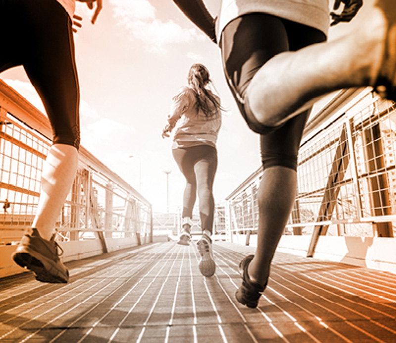 Athletes running on bike trail