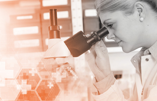 Researcher looking through a microscope