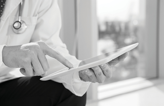 Medical provider looking at tablet