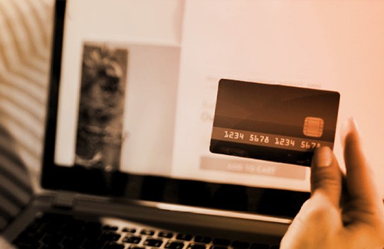 Person making an online purchase with a credit card