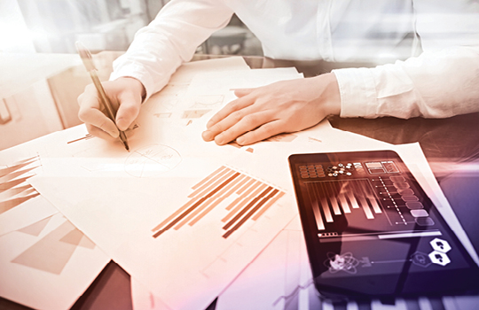 Two people collaborating over an annual report chart