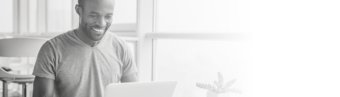 A man typing on a laptop