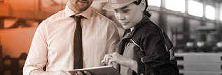 Two people reviewing a manual