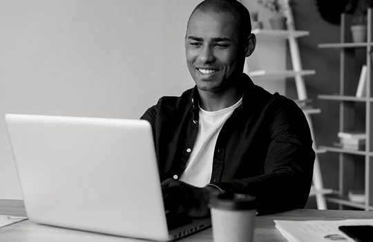 A man looking at a laptop 