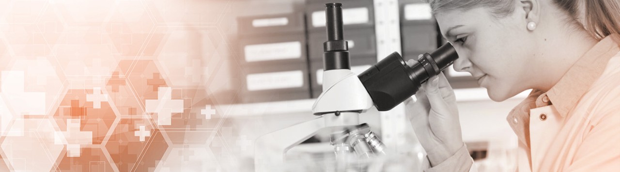 Researcher looking through a microscope