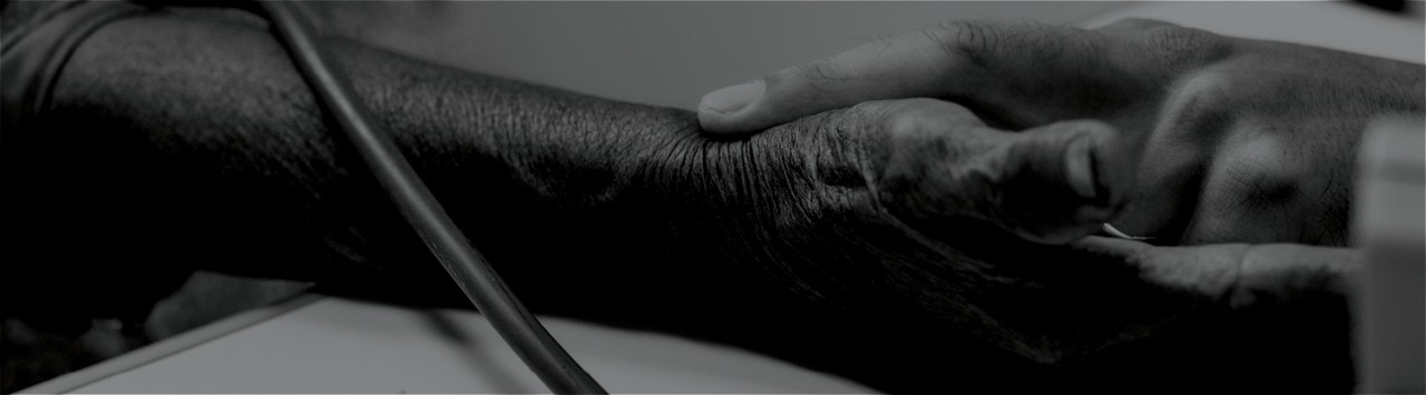 A healthcare worker checks the pulse of a patient.