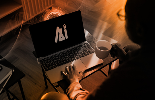 A person drinks coffee while working on a laptop.