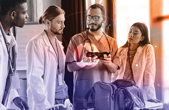 Provider showing a medical device to medial providers