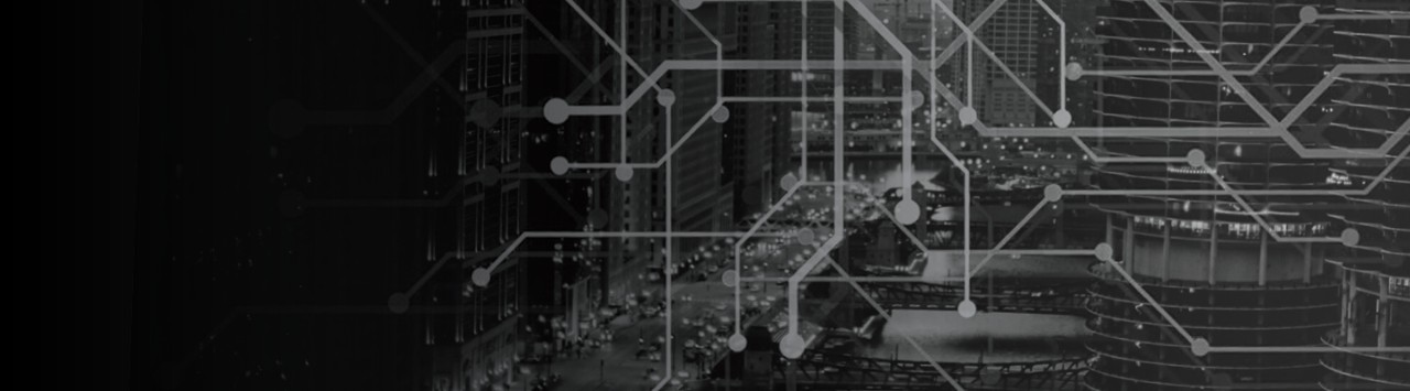 The black and white photo shows a geometric pattern of line segments over the image of a city scene. Skyscrapers create the landscape and car headlights illuminate the dark sky. The photo suggests movement and the need to evaluate a multivendor strategy..