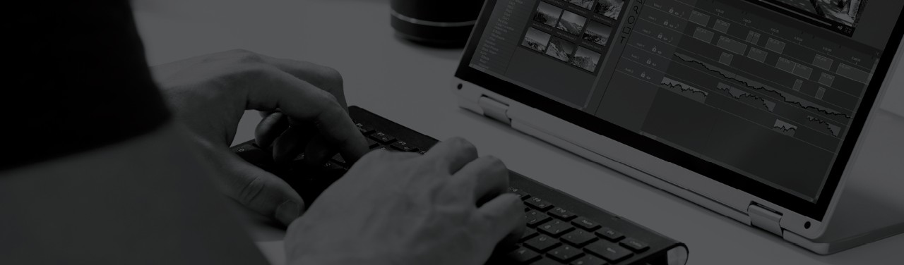 Person adding captions in video editing software