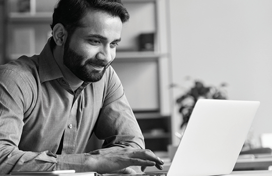 A man looking at a laptop 