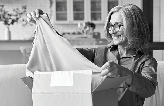 Person taking a new clothing purchase out of a box