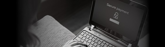A person completing a secure payment on a laptop