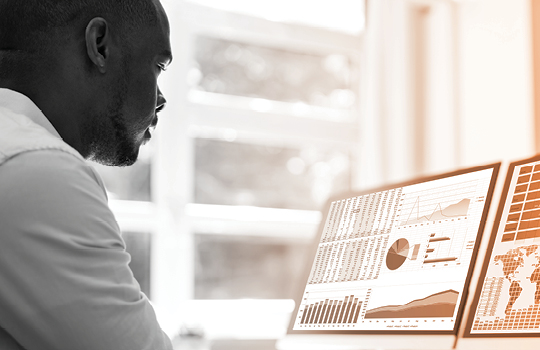 Person looking at computer to track quality metrics across deliverables