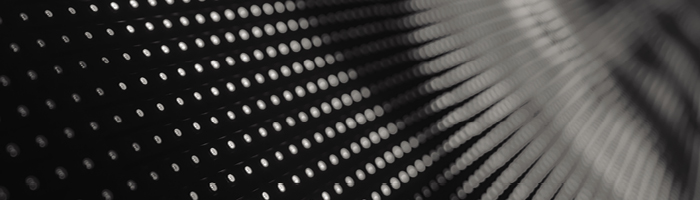 A grid of white dots blurs to the top right corner of a dark background.