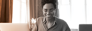 Woman smiling before a computer screen